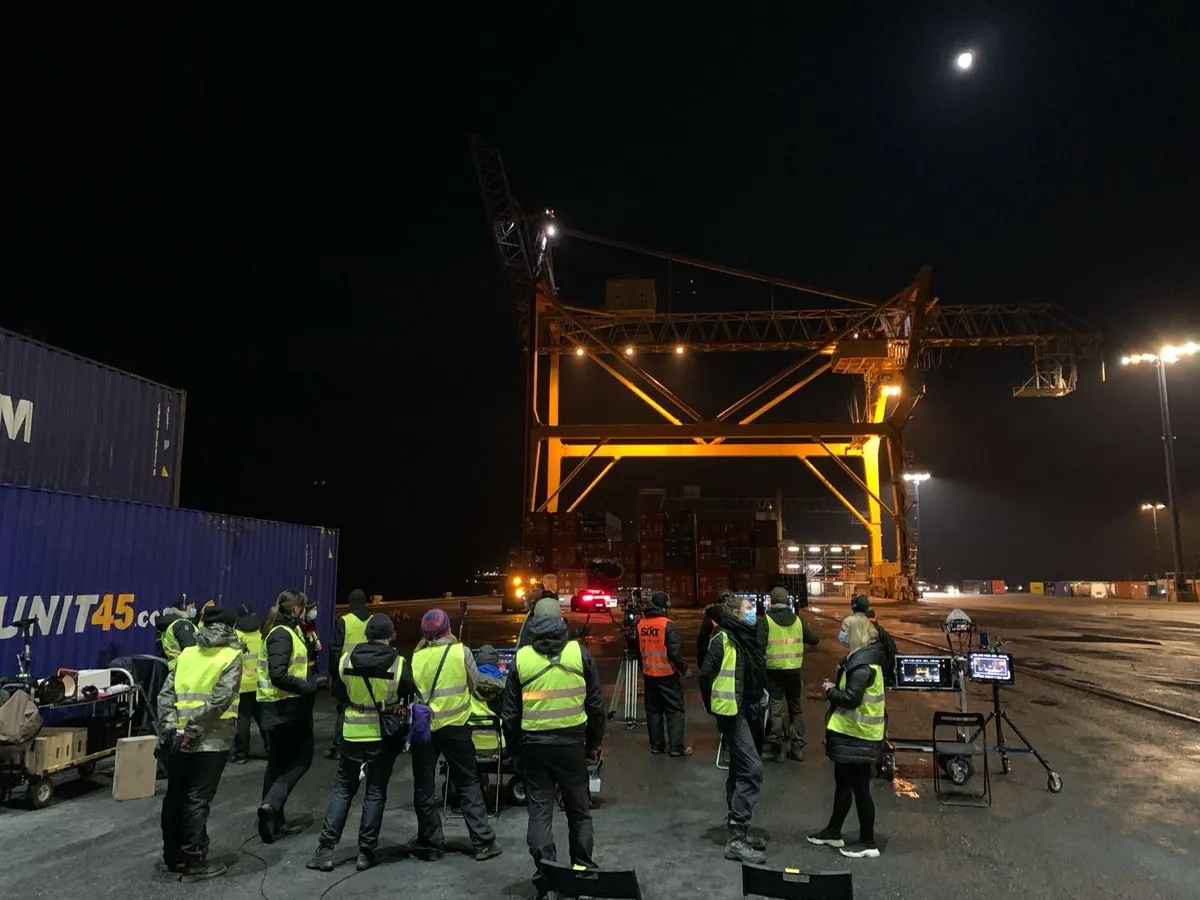 Crew gathered around a large night lighting rig