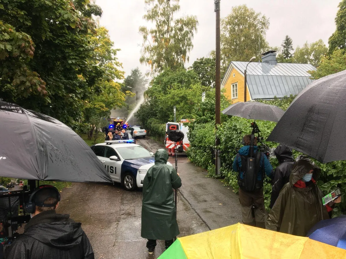 Film crew working at a rainy location