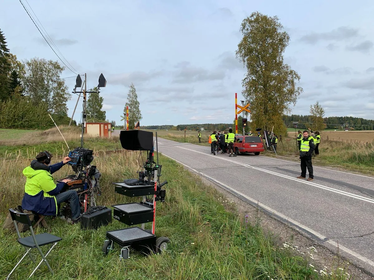 Production crew operating beside a rural road