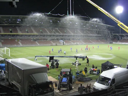 Production rig and crew working in a stadium